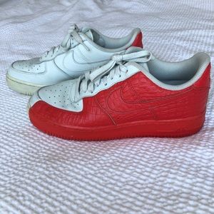 Half red snake skin, half white Air Force ones.